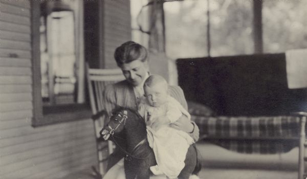 Georgia Lloyd Jones holds her son Jenkin Lloyd Jones, born Nov. 1911, on a hobby horse.