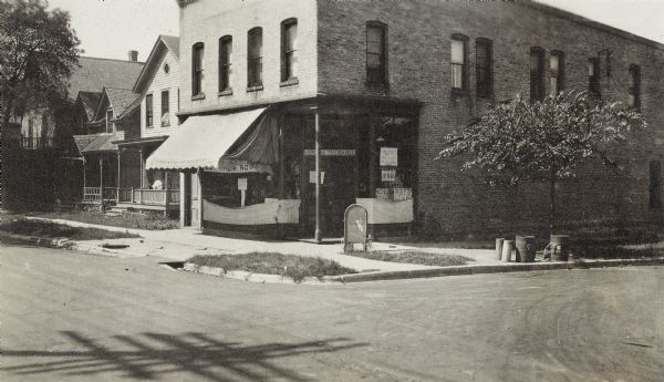 Walter M. Atwood's Drug Store, 1054 Williamson Street, from 1914 to 1945. The family lived upstairs until 1937.  Signs in the windows read "Kodaks," and "U.S. Postal Station No. 2."