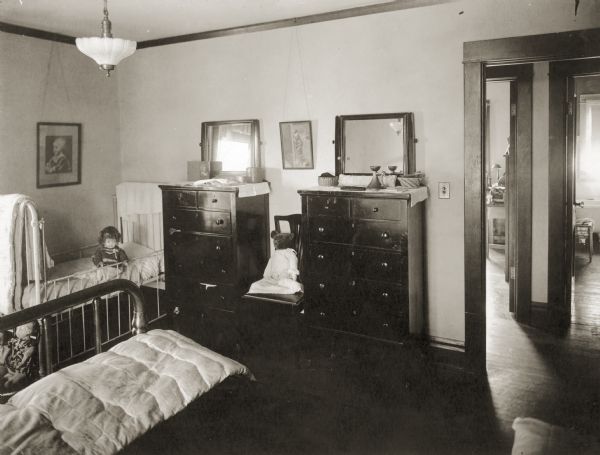 Florence (Bis) Lloyd Jones and guest bedroom, in the Richard Lloyd Jones home, 1010 Walker Court (now 1010 Rutledge Court).  Two dolls and a Teddy bear share the room.