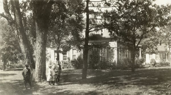 French Second Empire style, C. Loftus Martin House, 327 Milton Ave., built ca. 1868. Three children stand in yard. Richard Lloyd Jones was born in Janesville in 1873 and lived there until Rev. Jones moved the family to Chicago in 1881. This picture was taken when Richard moved his family from Madison to Tulsa, Oklahoma, in 1919.