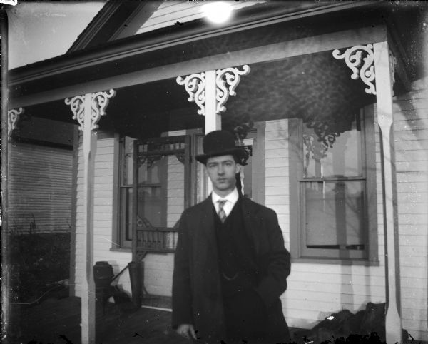 Otto Lindner standing in front of a rooming house.