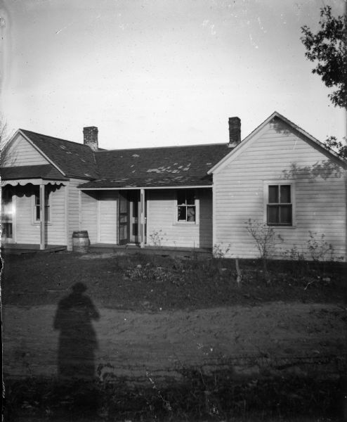 Shadow of photographer and unidentified house.