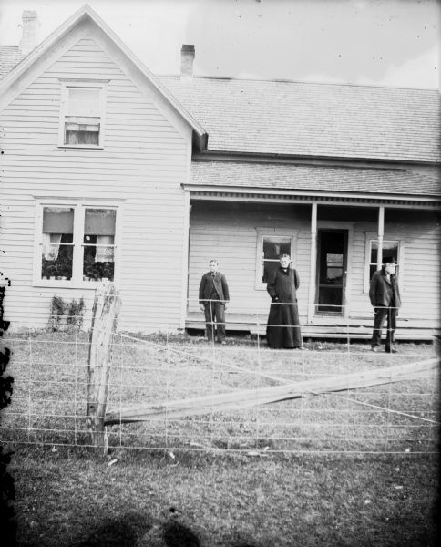 People standing in front of home, possibly that of Orlando Mathews.