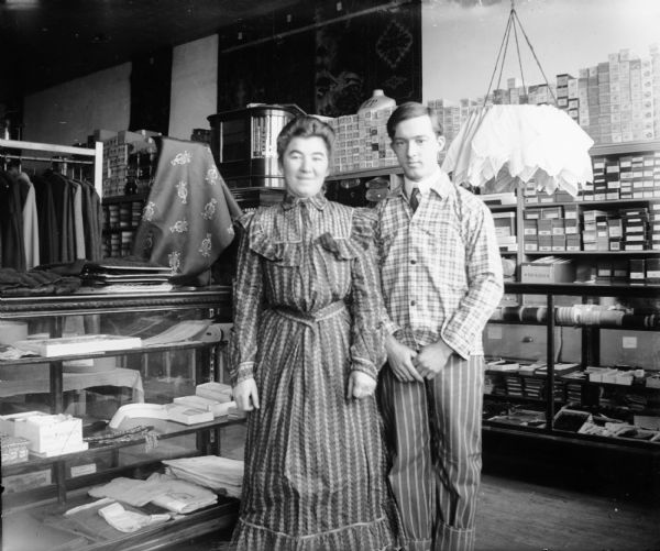 Interior portrait of Otto Lindner and unidentified woman in mercantile store.