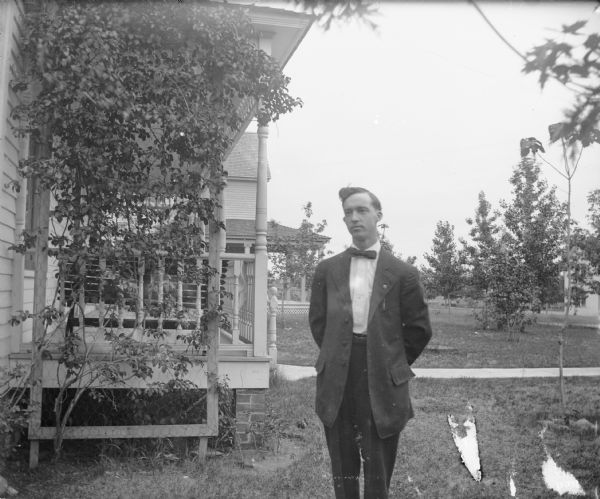 Outdoor portrait of Otto Lindner near house.