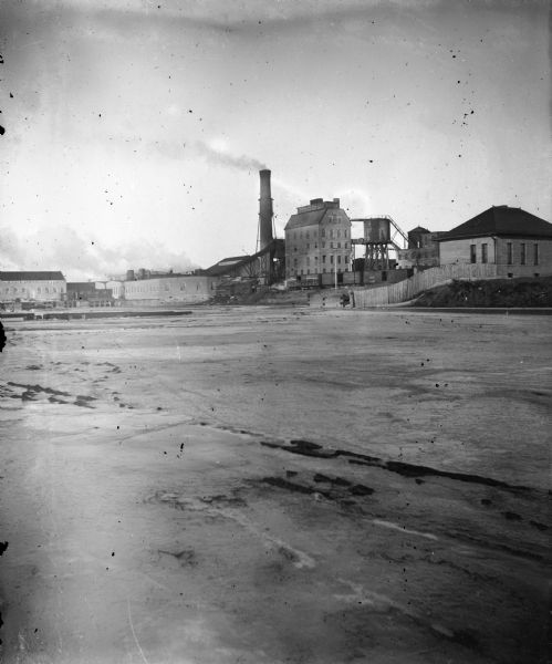 Exterior view of the Nekoosa-Edwards paper mill with river in foreground.