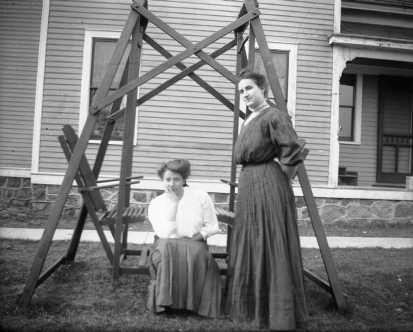 Two unidentified women pose near platform swing at the Otto Lindner house.
