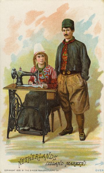 Chromolithograph card of a Dutch couple from Island Marken in the Netherlands in "native" Dutch costume, posing next to a Singer sewing machine. Part of a "Costumes of All Nations," set created as a souvenir at the 1893 World's Columbian Exposition.