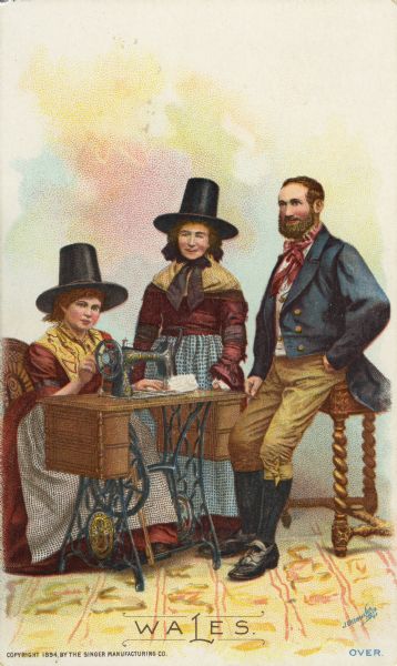 Chromolithograph card of two women and one man from Wales in "native" Welsh costume, posing next to a Singer sewing machine. Part of a "Costumes of All Nations," set created as a souvenir at the 1893 World's Columbian Exposition.