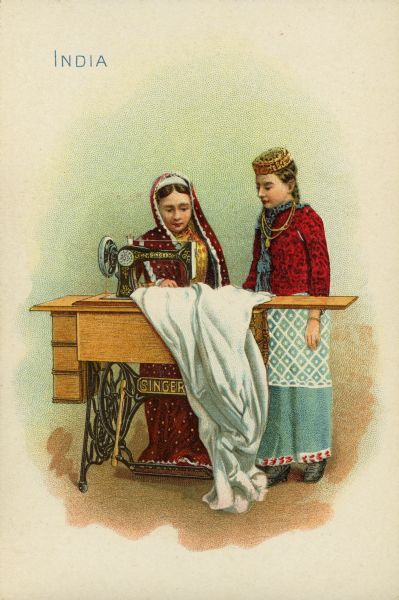 Chromolithograph card of two girls from India in "native" costume, posing near a Singer sewing machine.