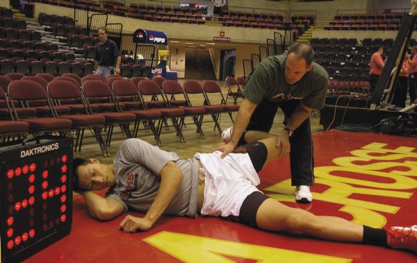 Milwaukee Bucks center Yi Jianlian stretching before his first NBA exhibition game.