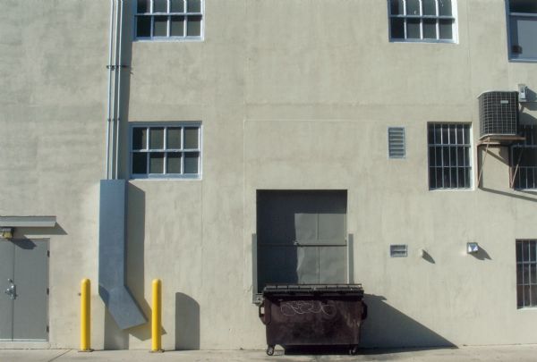 Street scene, with a dumpster in an alley.