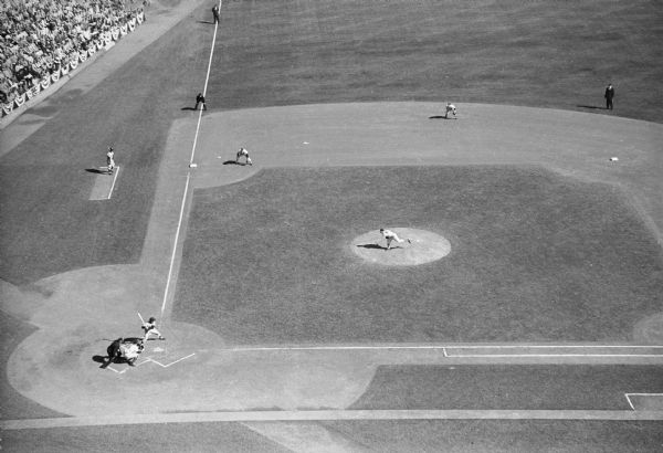 Elevated view of player preparing to swing at a baseball during the first game of the 1958 World Series, at County Stadium.