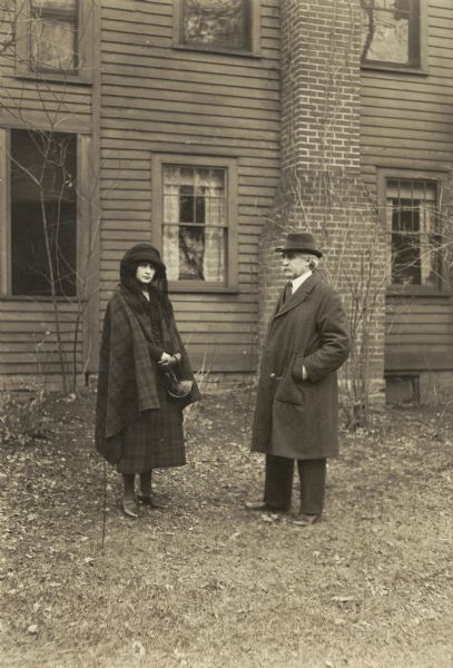 Informal portrait of writer Hamlin Garland at his family home in West Salem. The woman with him has been tentatively identified as his daughter, Mary Isabel Garland.