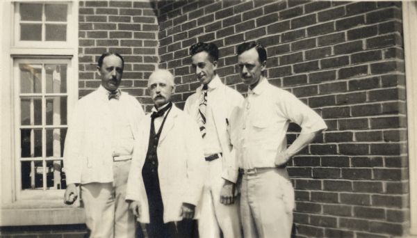 Doctor James A. Jackson, Sr., of Madison (center), with three of his four sons who became doctors: (left to right) Reginald H. Jackson, Sr., Arnold Jackson, and James A. Jackson, Jr. at about the time the family established the Jackson Clinic.