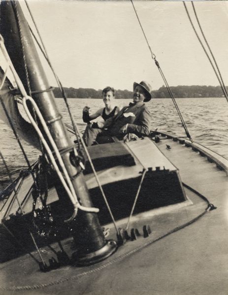 Dr. Reginald Jackson, Sr., and his son Reginald Jr., in the family sailboat.  Because the family's cottage was located near Picnic Point, the photograph was probably made on Lake Mendota.