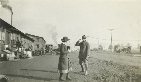 Colonel Joseph W. Jackson, formerly of Madison, Wisconsin, and Williston, North Dakota, salutes a woman in civilian dress at Camp Lewis.  Jackson was an officer in the U.S. Remount Service which was training at the camp.