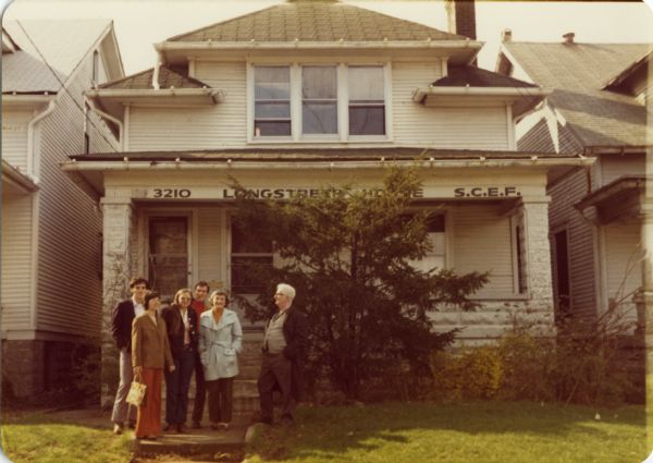 Group standing in front of the SCEF (Southern Conference Education Fund) headquarters.  The group includes Anne Braden in the blue jacket, and Carl Braden to her left.  The building was later renamed the Braden Center after Carl's death.