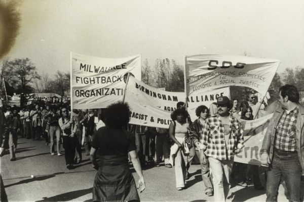 Unidentified protest march, with the banner of the Southern Organizing Committee for Economic and Social Justice (SOC) in front.  The banner of the Milwaukee Fight-back Organization can be seen behind it.