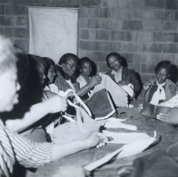 Women of the Haywood Handicrafters, a civil rights project established for black women in Haywood County, Tennessee.  Many of these women had been subject to economic reprisals as a result of their participation in the voter registration efforts of the early 1960s.  The leather bags they made were promoted by civil rights groups around the country and in many cases were their only source of income.
