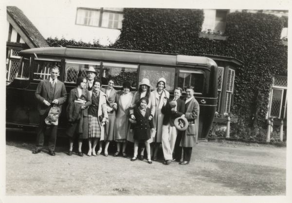 A group of Rotarian tourists pose next to their tour bus in England.  Joseph Jackson of Madison, the tall man in the back row wearing a hat, was a national leader of Rotary International in that year.