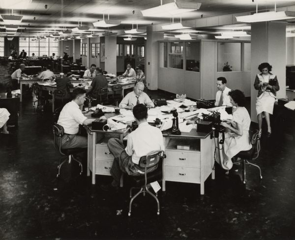 Newsroom of the <i>Louisville Times</i>, where Anne (typing, at the right), and Carl Braden (left), worked as journalists.