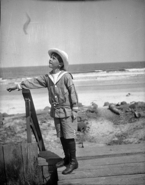 Reginald Jackson, Jr., posed at the beach wearing a sailor suit and hat.  The photograph was probably taken during a family vacation to the Biloxi area.  Jackson was an only child of a well-to-do physician and photographs of him in the family album depict this and other fashionable children's attire from the early turn-of-the century years.