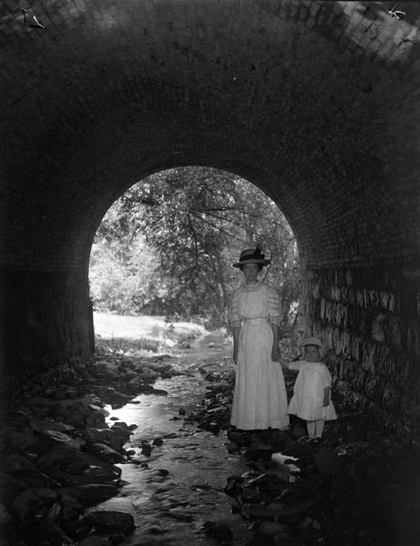 Hattie Taylor and daughter Tannisse walk under a Milwaukee park culvert.