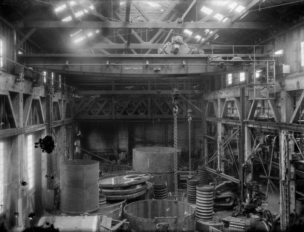 Interior view of Pawling & Harnischfeger 20-ton type "N" dial controlled cab-operated traveling crane in a machine shop with boiler tubs. The location is possibly Lookout Boiler & Manufacturing Co. in Chattanooga, Tennessee, or Kewanee Boiler Co. in Milwaukee, Wisconsin.
