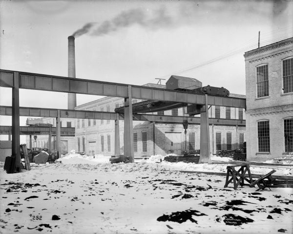 Two Pawling & Harnischfeger type "A" outdoor yard cranes at the Allis-Chalmers Manufacturing Co. Stamped on the crane are the words "Pawling & Harnischfeger Builders, Milwaukee, Wis, Capacity 80,000 Lbs., No. 636." The photograph is signed in the lower right corner "J.Brown, Photo, Milwaukee."
