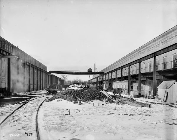Exterior view of a 10-ton type "A" semi-gantry crane at the Allis-Chalmers Manufacturing Co. foundry yard. The crane is stamped with the text "Pawling & Harnischfeger Builders, Milwaukee, Wis, Capacity 20,000 Lbs., No. 647." The photograph is signed in the lower left corner "J.Brown, Photo, Milwaukee."