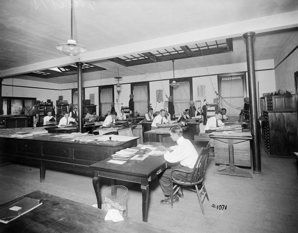 Men at their desks in the engineering department, the south end drafting room, of Pawling & Harnischfeger.