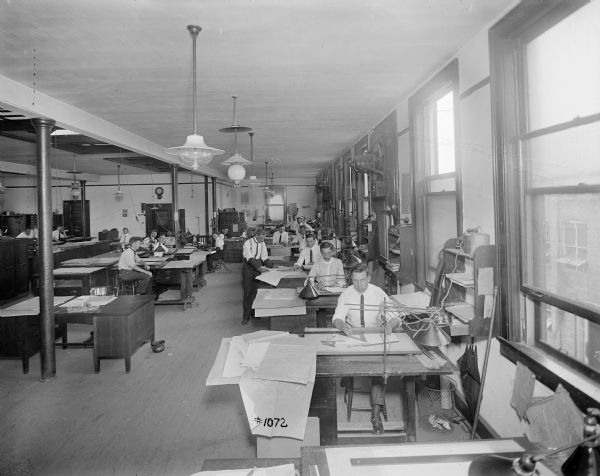 Men at their desks in the engineering department, the north end drafting room, of Pawling & Harnischfeger.