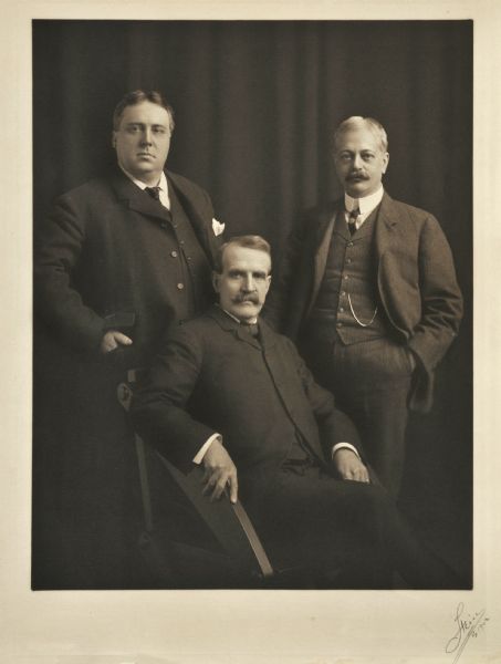 Studio group portrait of (left to right) Charles F. Pfister, Henry C. Payne, and Frank G. Bigelow.<p>Pfister was a Milwaukee financier, who - among numerous business interests - was the owner of the Pfister Hotel and the <i>Milwaukee Sentinel</i>; see also Image ID# 62417).<p>Payne served as director of the First National Bank of Milwaukee, president of the Wisconsin Telephone Company, Milwaukee and Northern Railroad, Milwaukee Electric Railway and Light Company, Milwaukee and Cream City Traction Company, and the American Street Railway Association. In 1893 he was appointed receiver for the bankrupt Northern Pacific Railway. He also served as the 40th U.S. Postmaster General, 1902-04.<p>Bigelow was president of the First National Bank of Milwaukee.