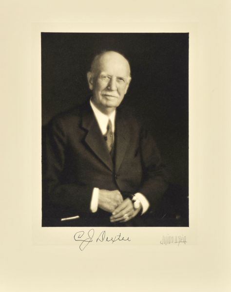 Waist-up seated studio portrait of Charles J. Dexter, Milwaukee grocer.