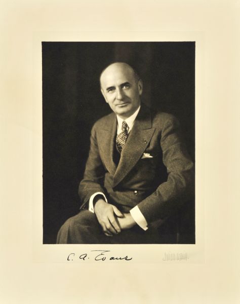 Three-quarter length seated studio portrait of Curtis A. Evans, Milwaukee surgeon.