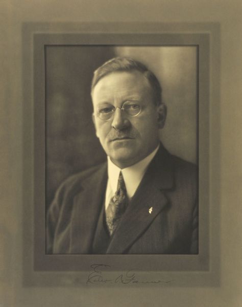 Quarter-length studio portrait of Edward A. Farmer, Milwaukee banker.