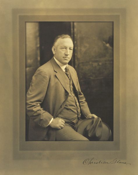 Waist-up seated studio portrait of Christian Glaus, Milwaukee banker.