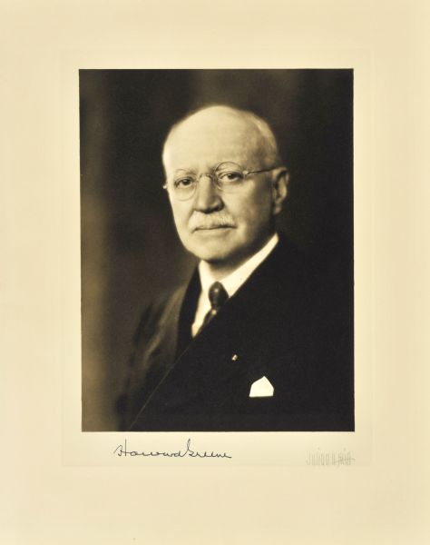 Quarter-length studio portrait of Howard Greene, Milwaukee company vice-president.