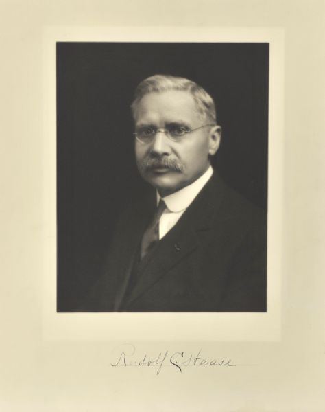 Quarter-length studio portrait of Rudolf C. Haase, Milwaukee company secretary.