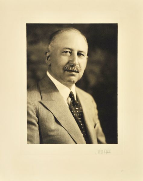 Quarter-length studio portrait of Carl Herzfeld, Milwaukee department store head.