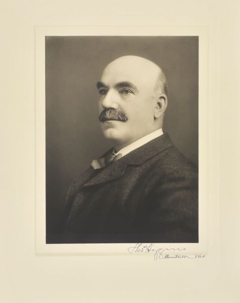Quarter-length studio portrait of Thomas Higgins, Manitowoc company president.