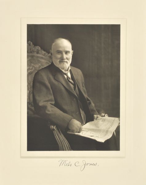 Three-quarter length seated studio portrait of Milo C. Jones, Fort Atkinson farmer and sausage maker.
