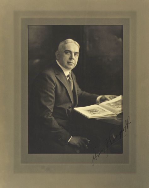 Three-quarter length seated studio portrait of Henry J. Langhoff, Milwaukee merchant.
