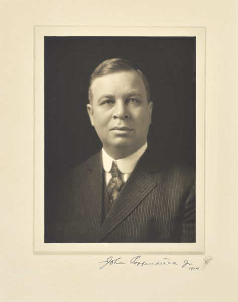 Quarter-length studio portrait of John Poppendieck, Jr., Milwaukee editor.