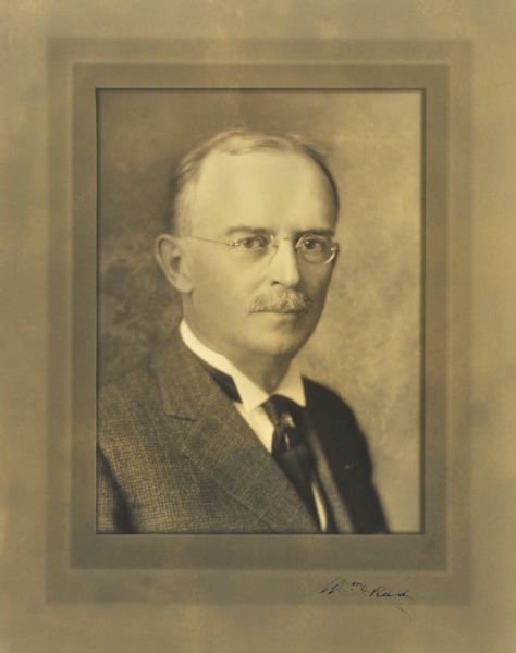 Quarter-length studio portrait of William D. Reed, Milwaukee company vice-president.