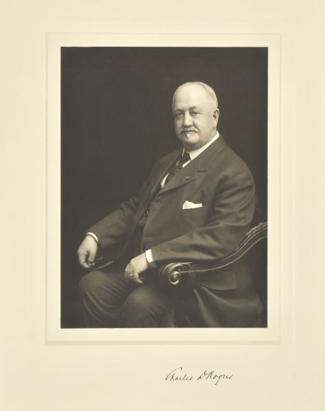 Three-quarter length seated studio portrait of Charles D. Rogers, Milwaukee realtor.