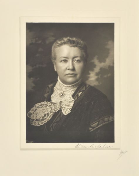 Quarter-length studio portrait in front of a studio backdrop of Ellen Clara Sabin, Milwaukee teacher and administrator.