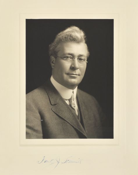 Quarter-length studio portrait of Frank J. Schmitt, Milwaukee contractor and builder.