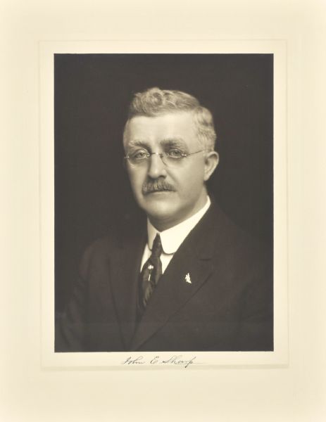 Quarter-length studio portrait of John E. Sharp, Milwaukee manufacturer.
